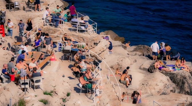 Tourists sunbathing on the rocks in 16th Century Dubrovnik, Croatia back in 2015